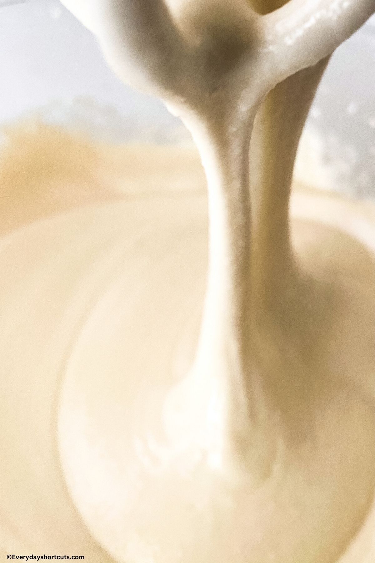 cream cheese frosting dripping from electric beaters