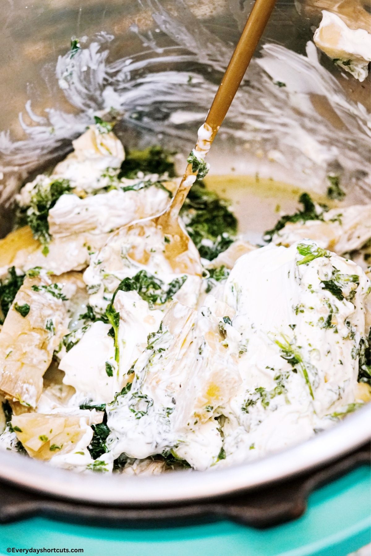stirring artichoke dip ingredients in an instant pot