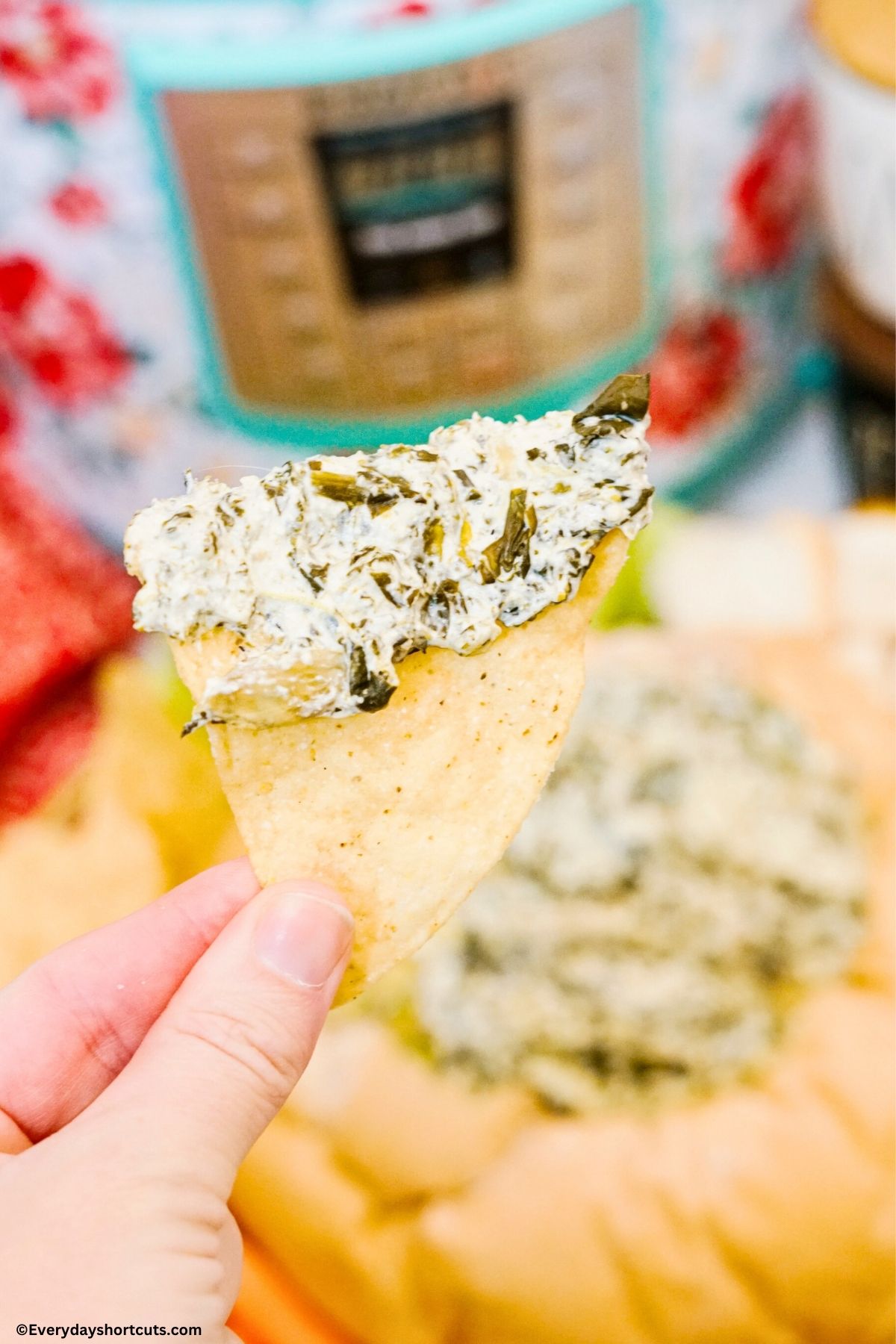 spinach artichoke dip on a tortilla chip