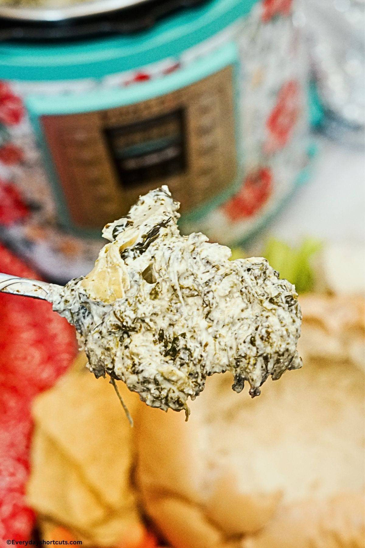 dip with spinach and artichoke on a spoon