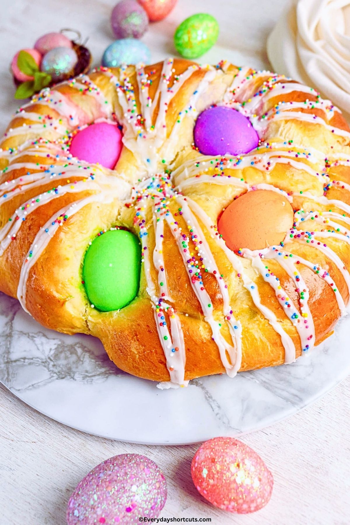 up close shot of Easter bread with colored eggs sprinkles and icing
