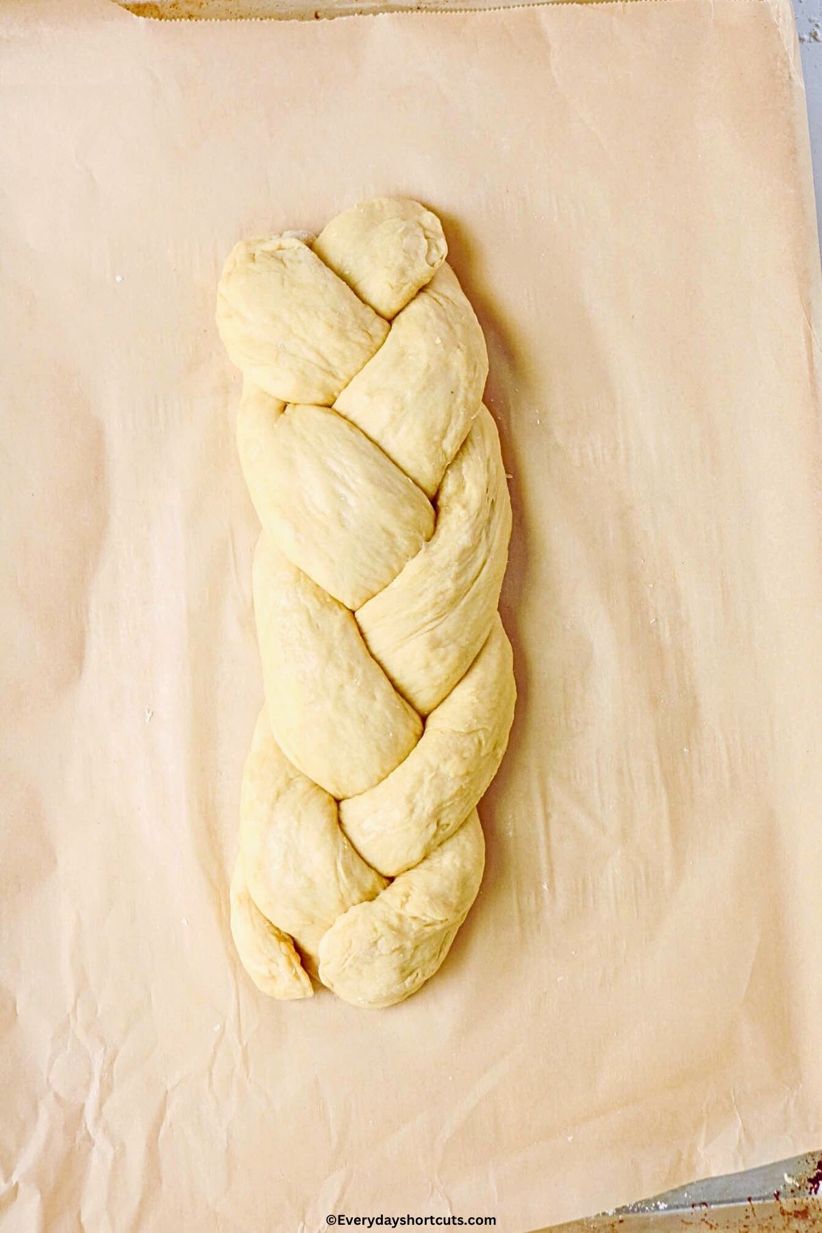 braid Easter bread on parchment paper