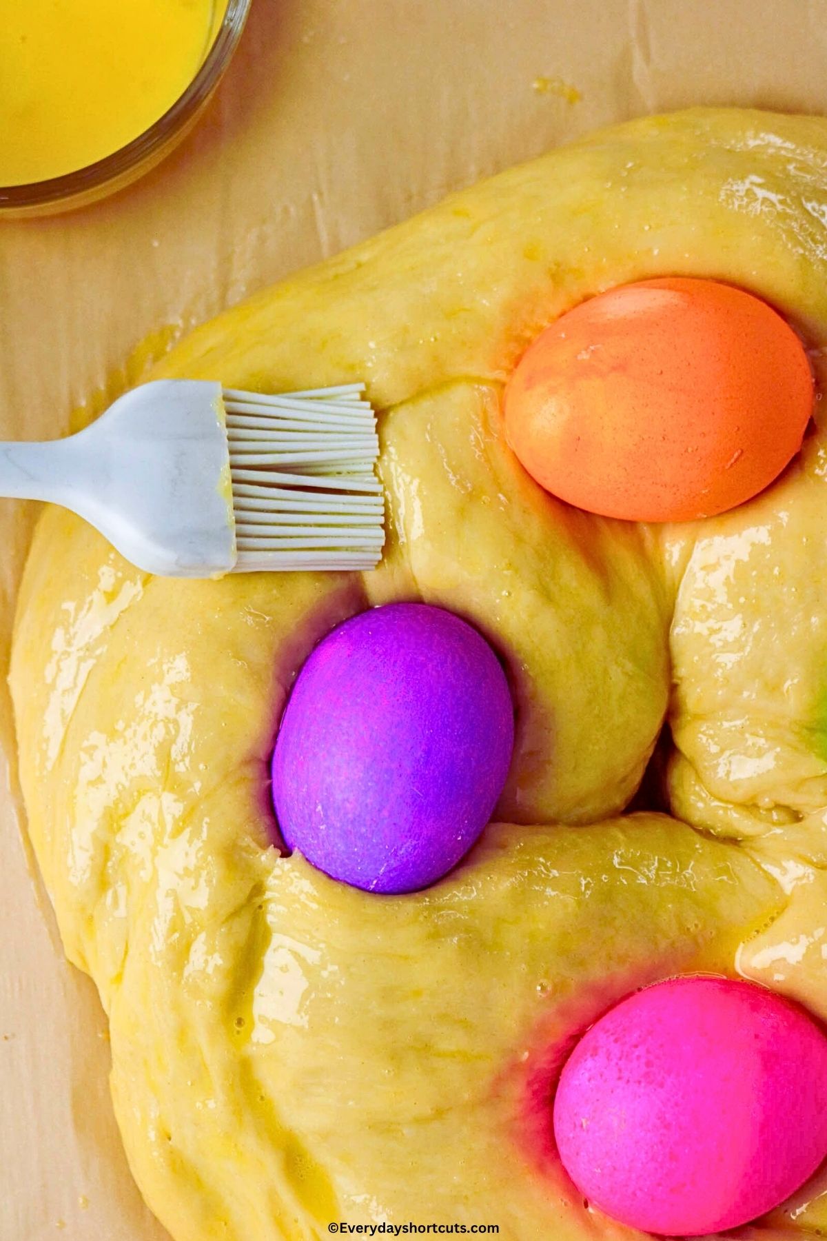 brushing egg was over top of Easter bread with basting brush
