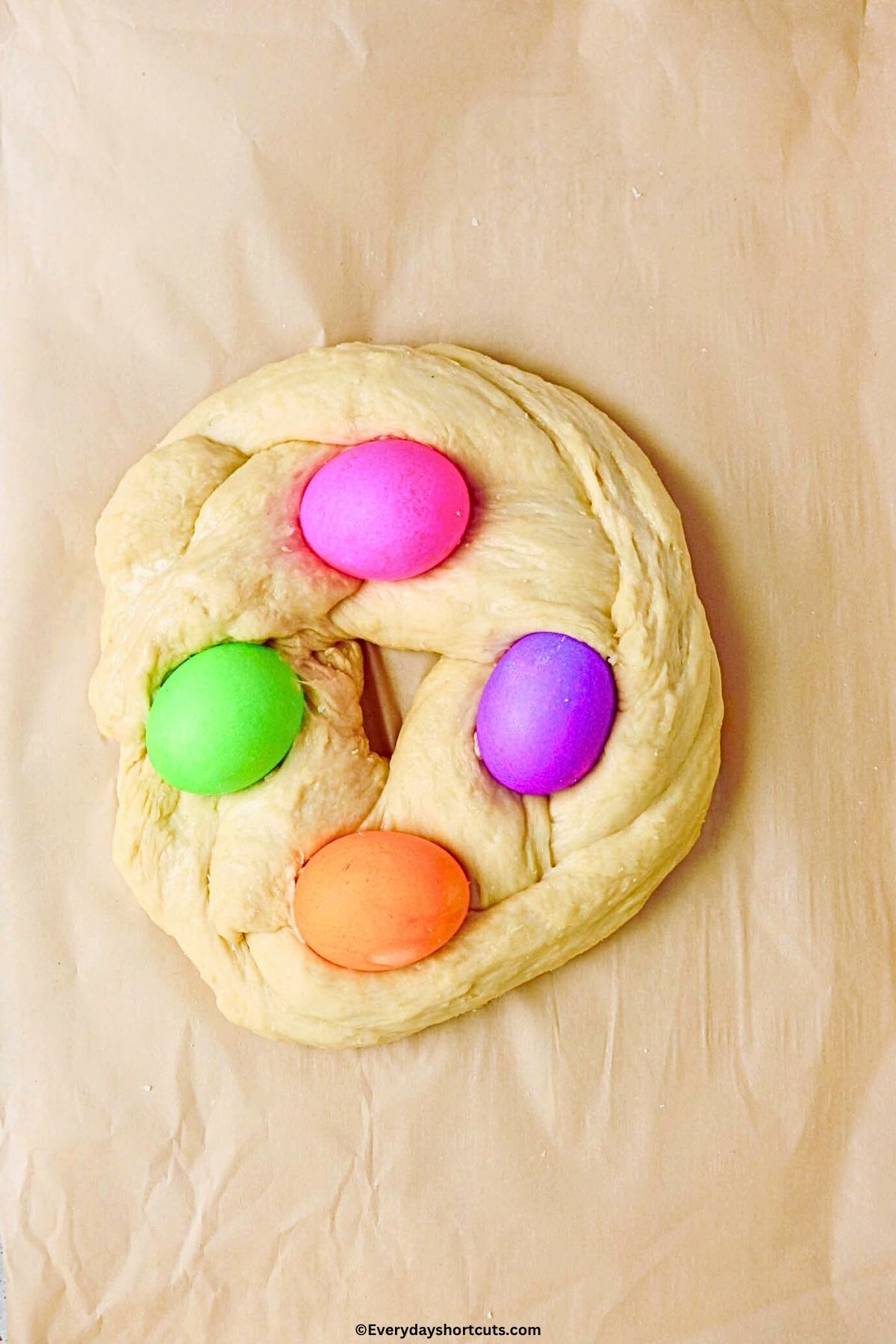 braided Easter bread shaped in a circle with colored eggs on top