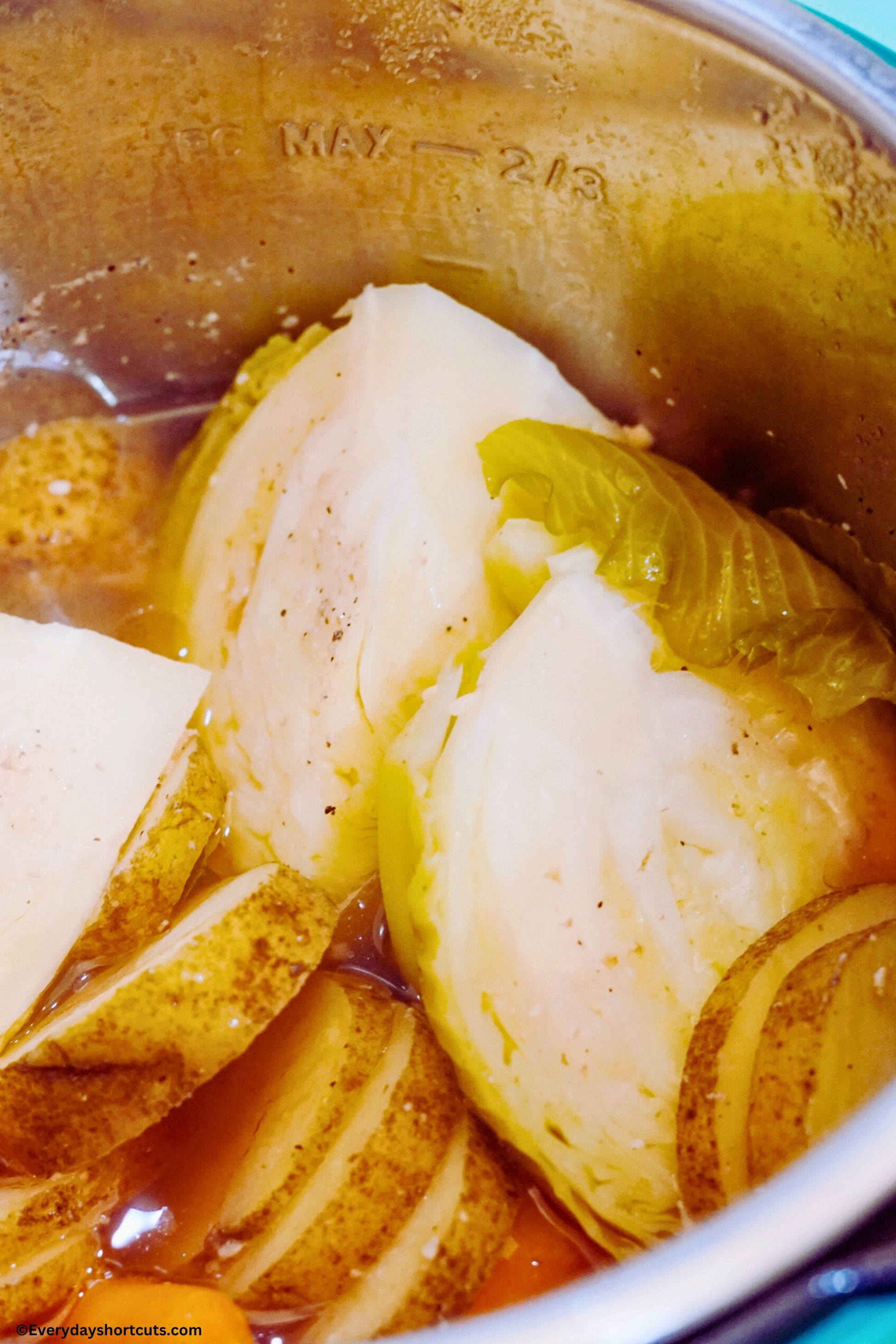 sliced potatoes onions cabbage in an Instant Pot with beef broth
