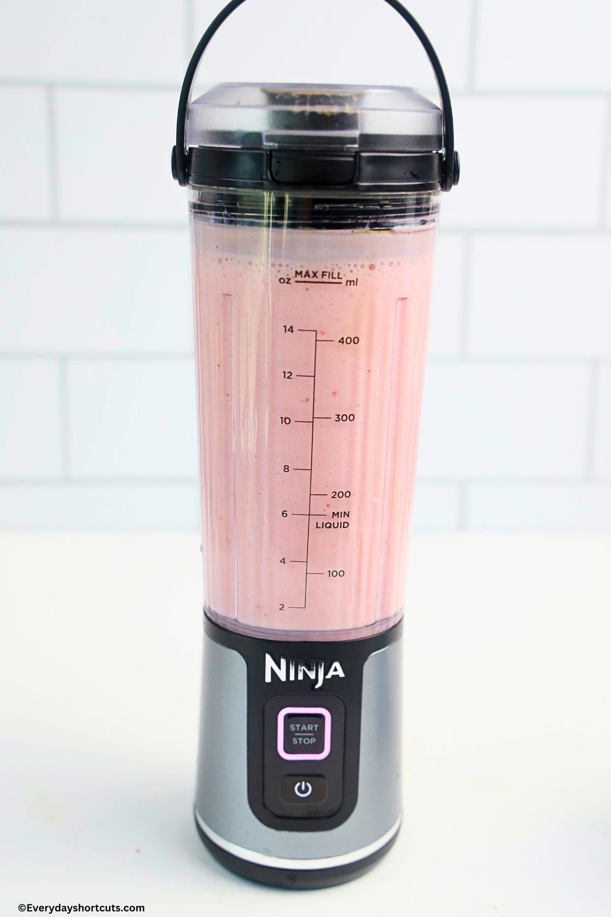 strawberry banana smoothie blended up in a blender