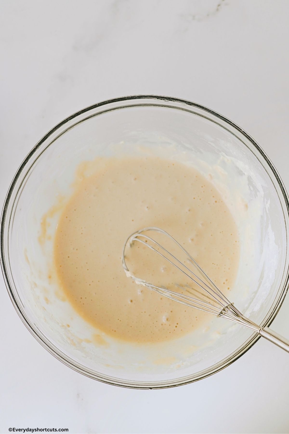 cobbler batter in a bowl with a whisk