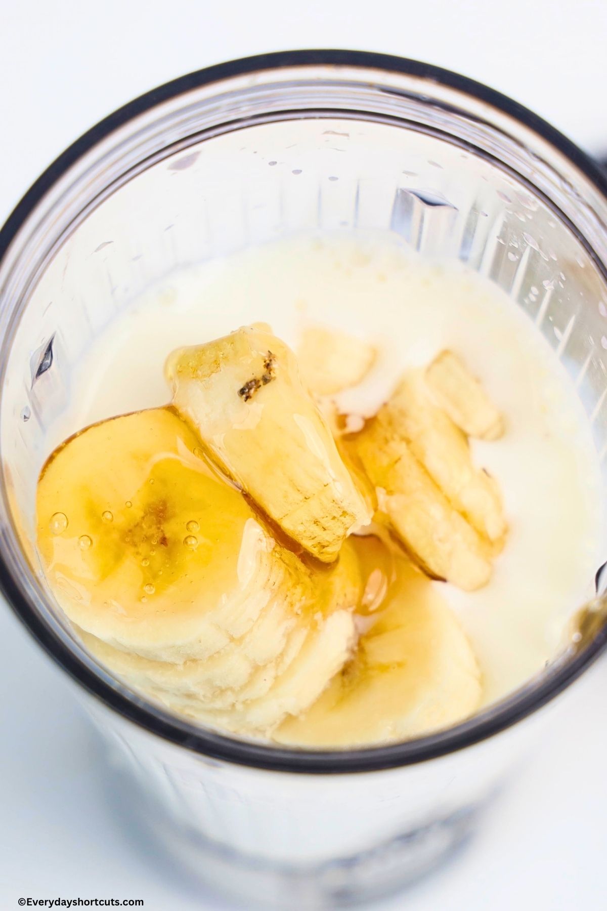 Greek yogurt, milk, banana, strawberries and honey in a blender