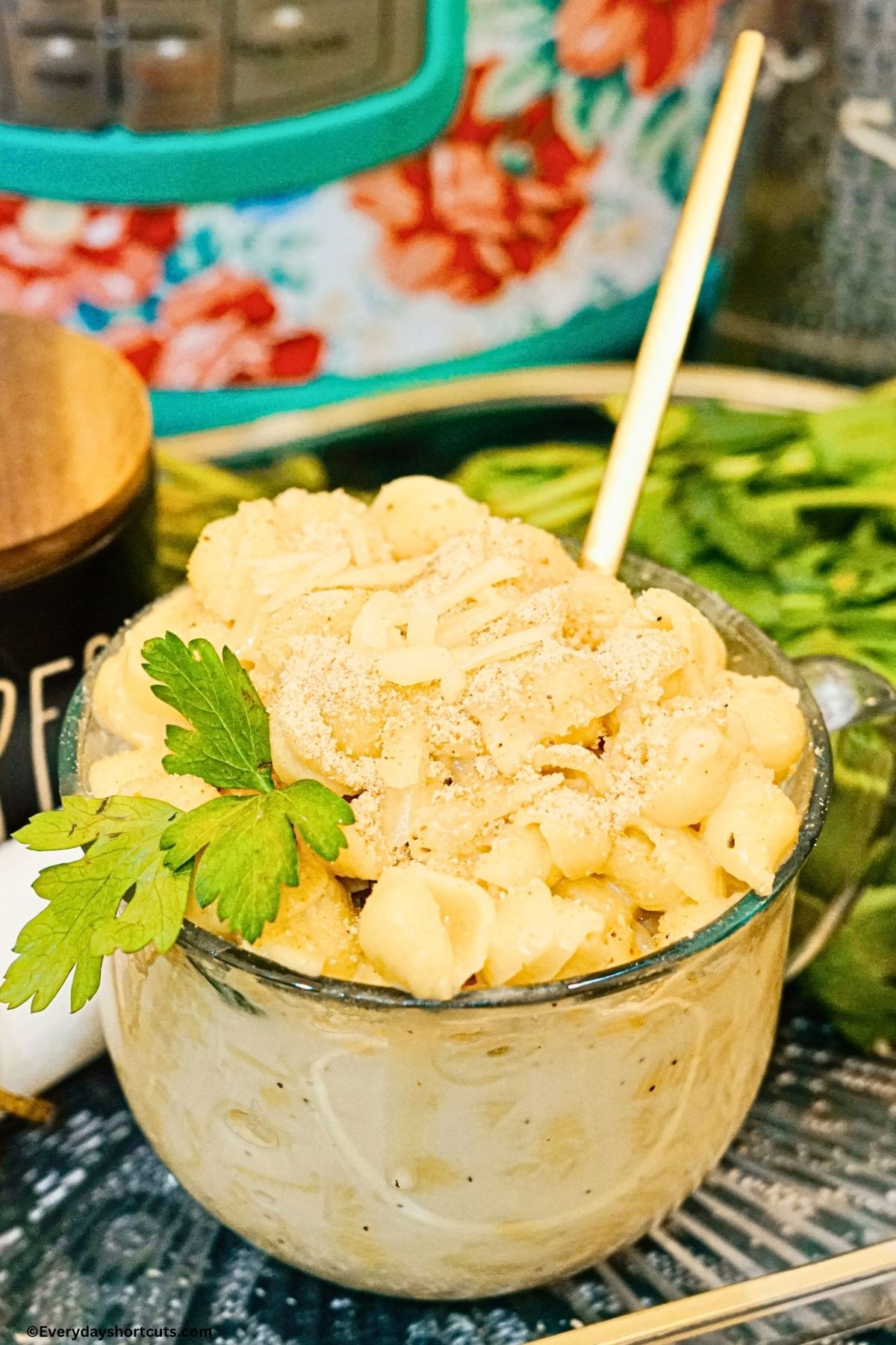 Panera mac and cheese copycat in a cup/bowl with spoon and parsley garnish
