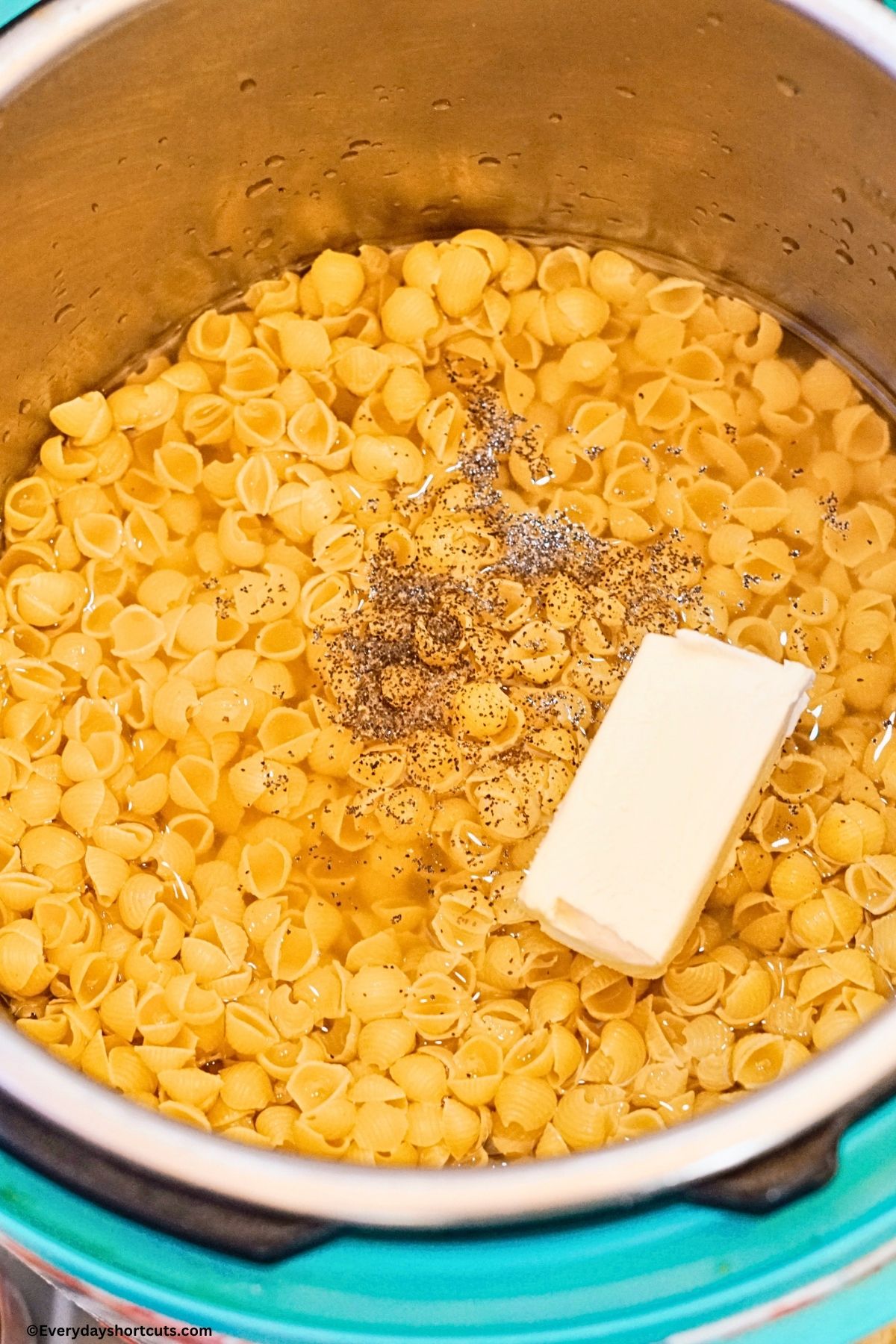 raw pasta shells, salt, pepper and butter with water in an instant pot
