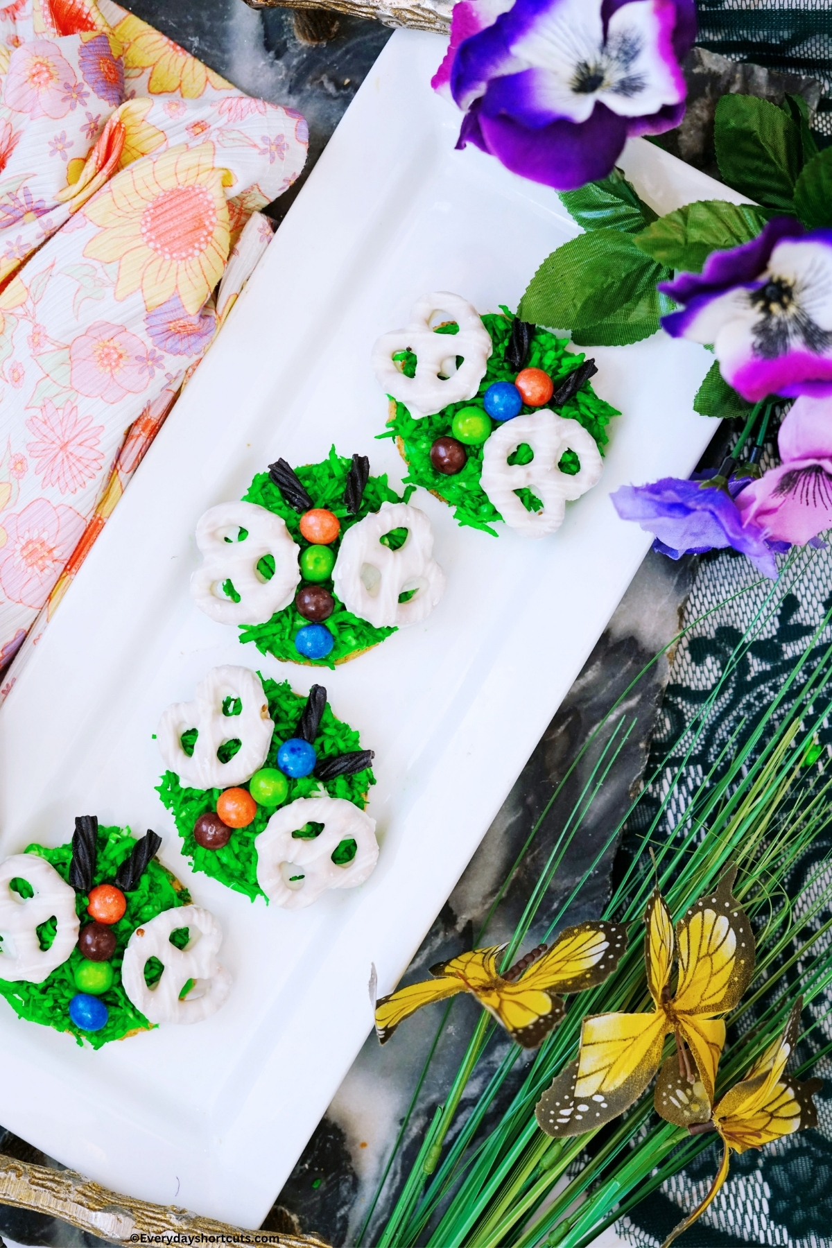 butterfly decorated sugar cookies on a white platter