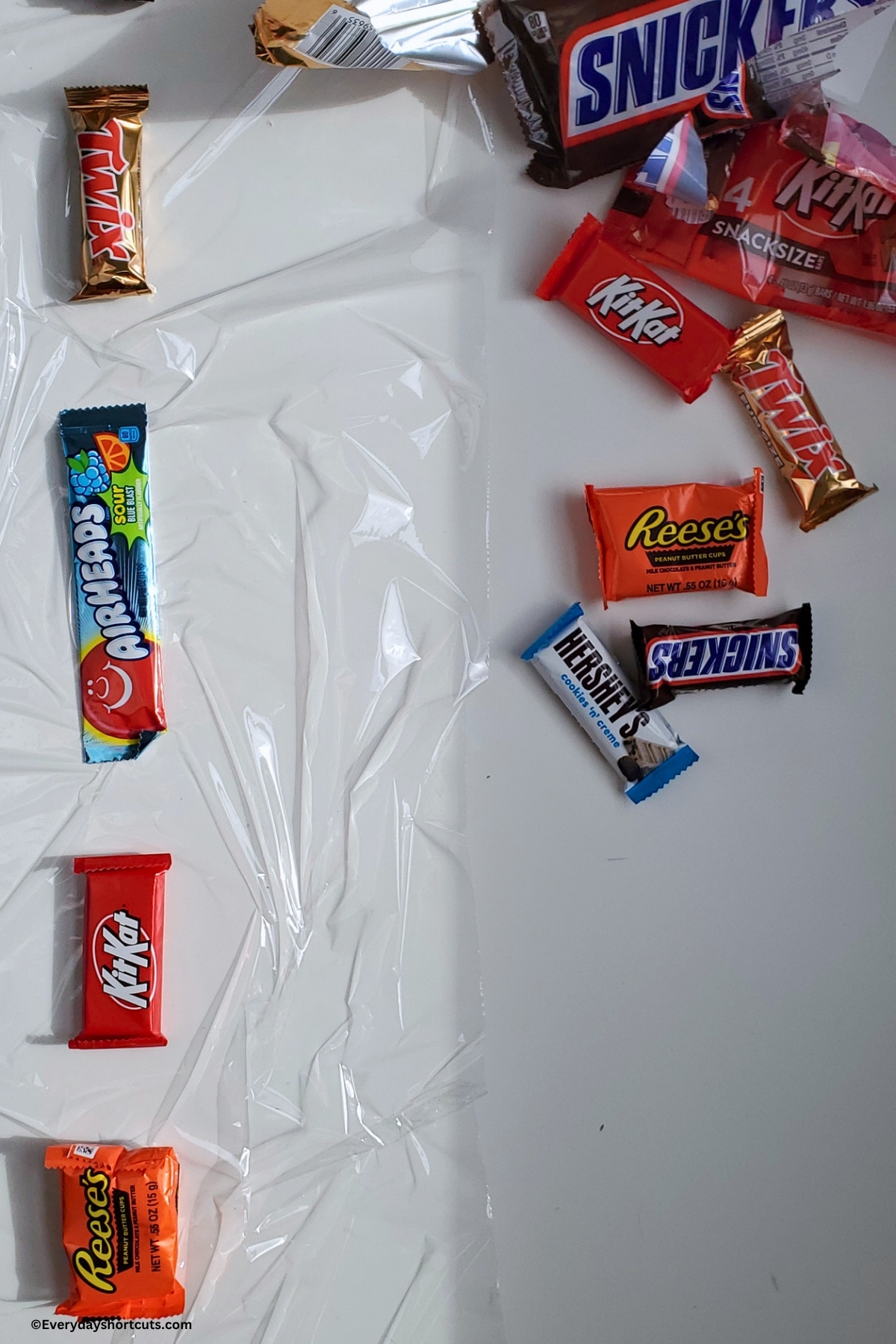 candy laid on the middle of plastic wrap strip