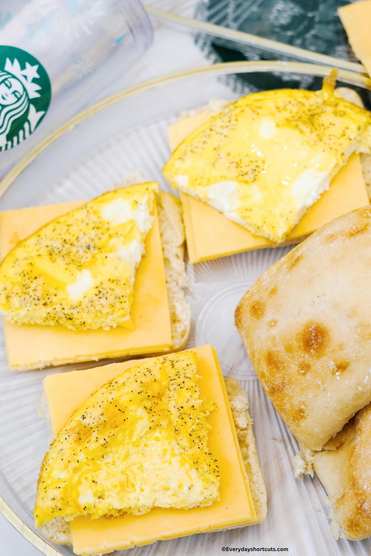 open faced ciabatta buns with a slice of cheese and egg patty