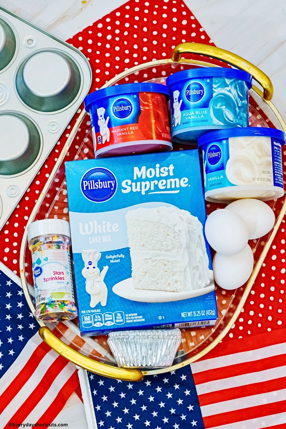 ingredients shown: white boxed cake mix, 3 eggs, star sprinkles, red, white and blue frosting