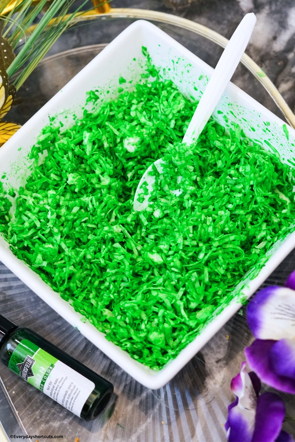 shredded coconut in a bowl mixed with green food coloring