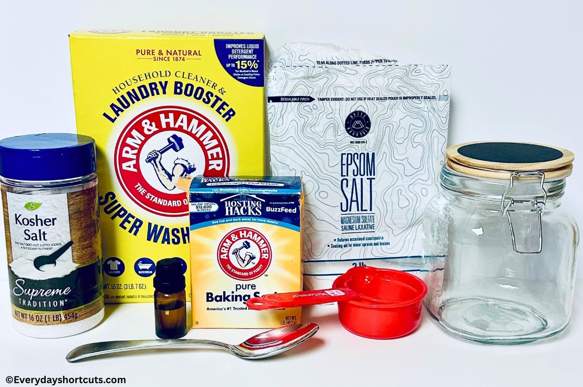 ingredients shown: kosher salt, washing soda, epsom salt, baking soda, essentials oils, glass jar, measuring cups and spoon