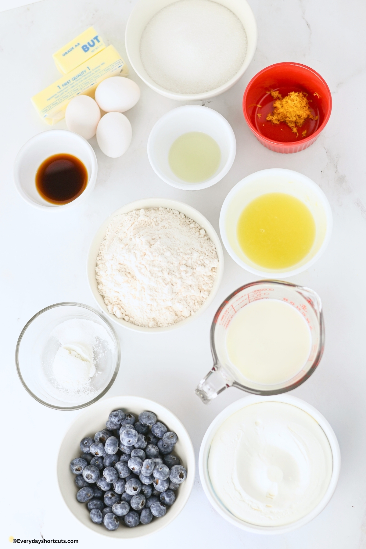 ingredients shown: Butter, Granulated Sugar, Eggs, Vanilla and lemon extract, Lemon Zest, Lemon Juice, All Purpose Flour, Baking Powder, Salt, Milk, Blueberries, Cool Whip
