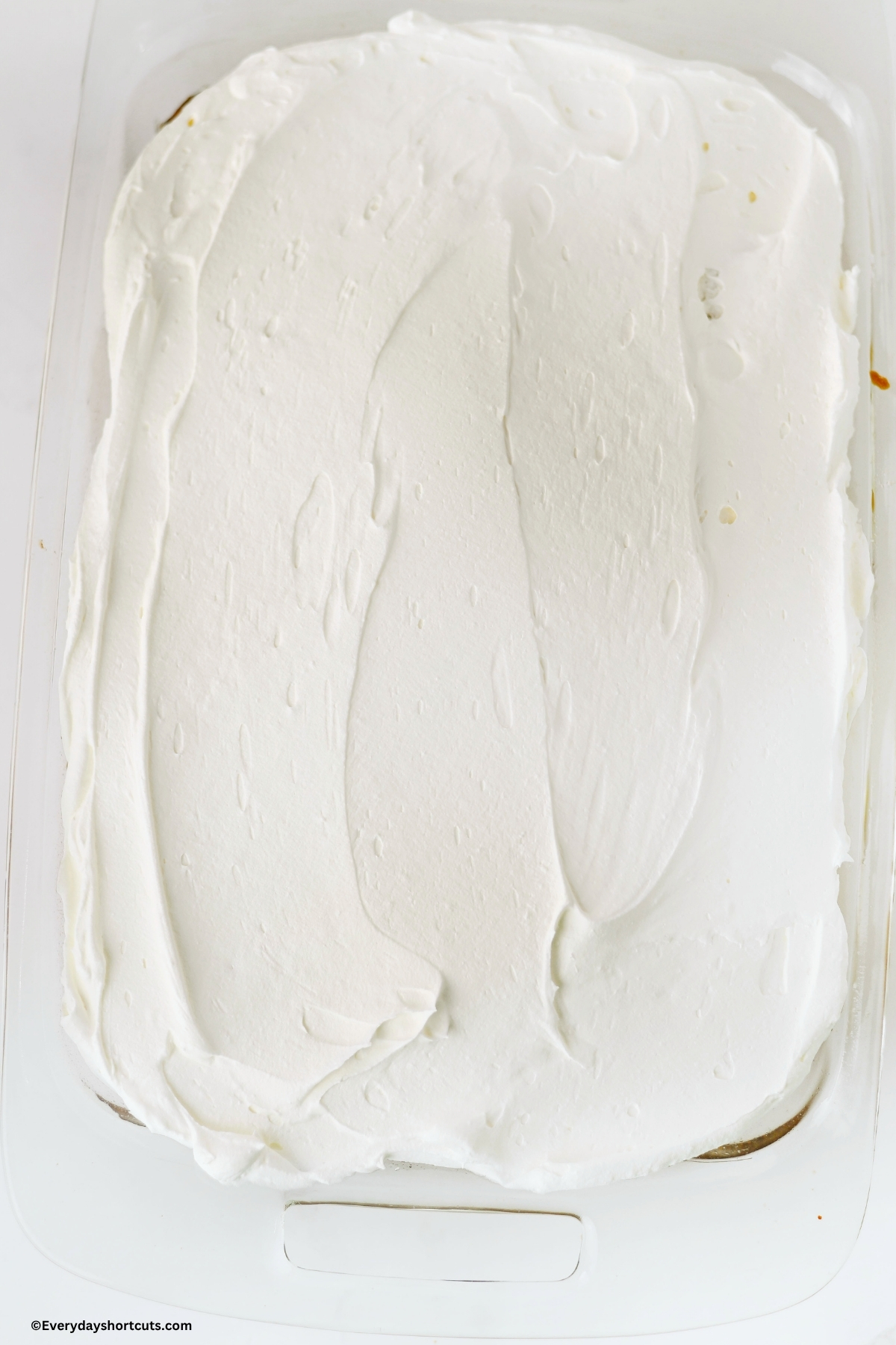 cool whip on top of cake in a baking dish