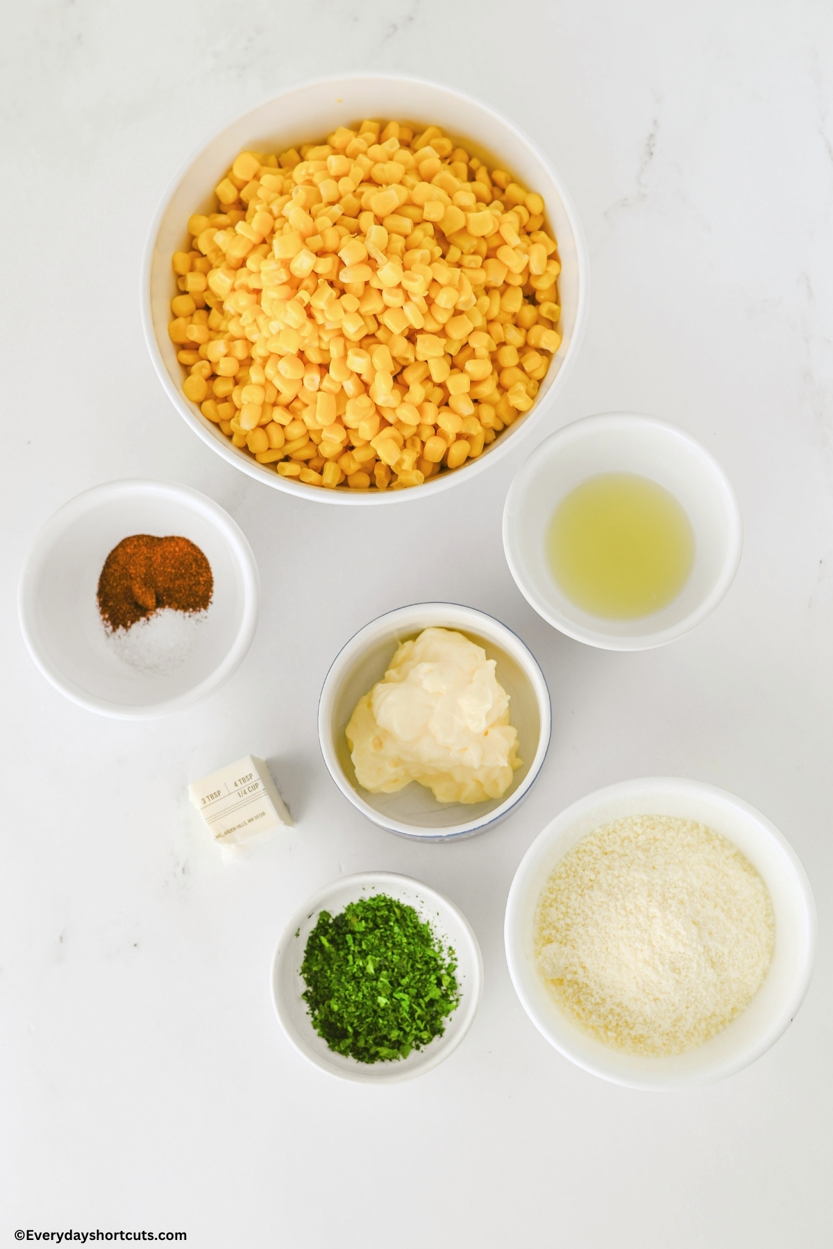 ingredients shown: corn, chili powder, salt, butter, cotija cheese, mayonnaise, lime juice, chopped cilantro