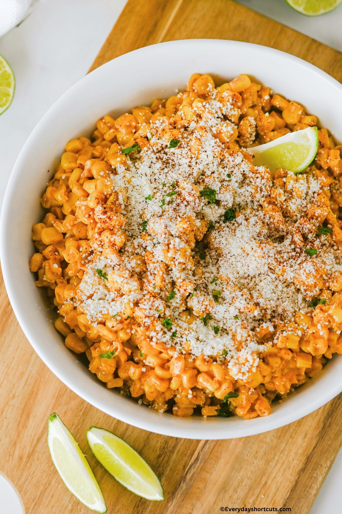 up close shot of bowl of Mexican street corn with cotija cheese sprinkled on top