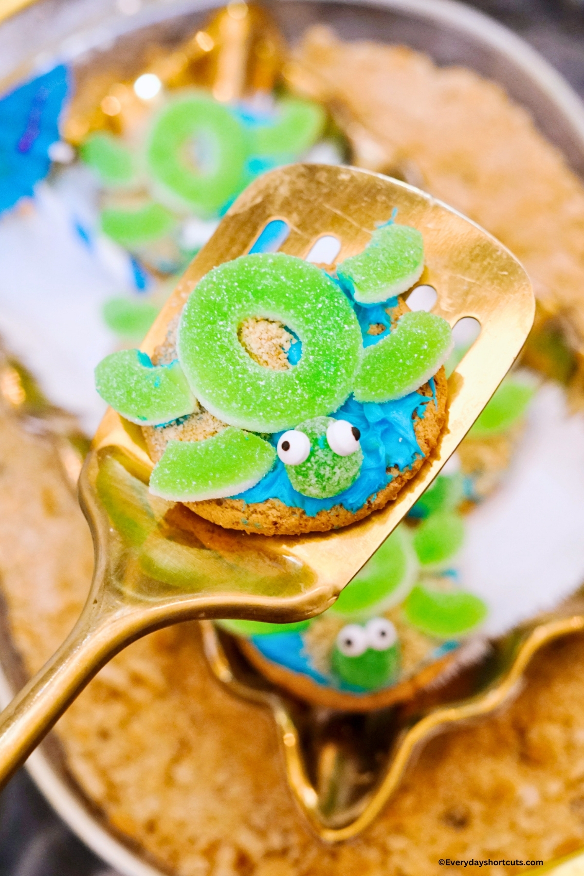 decorated sugar cookie to look like a sea turtle on a spatula