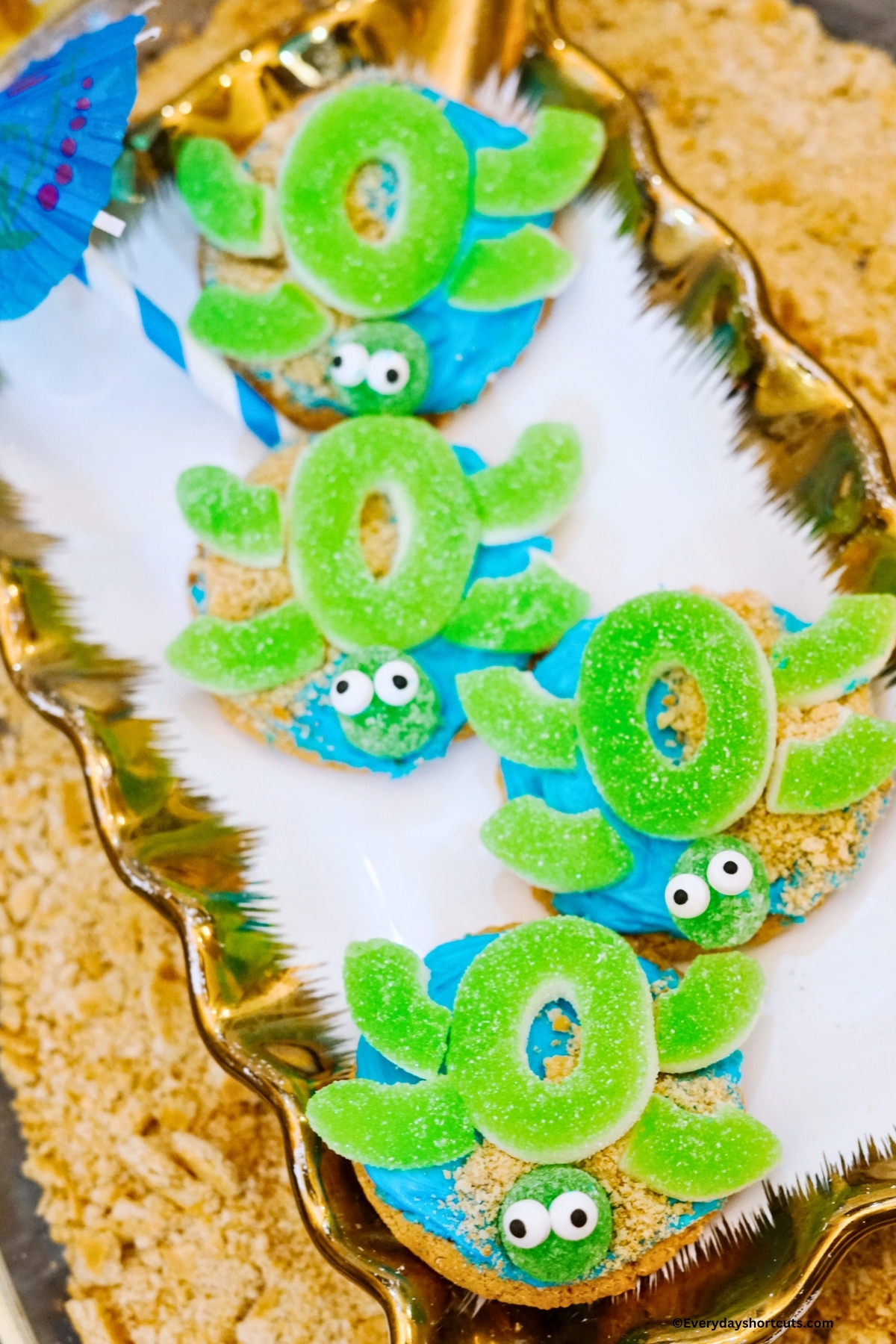 sea turtle decorated sugar cookies on a white and gold platter