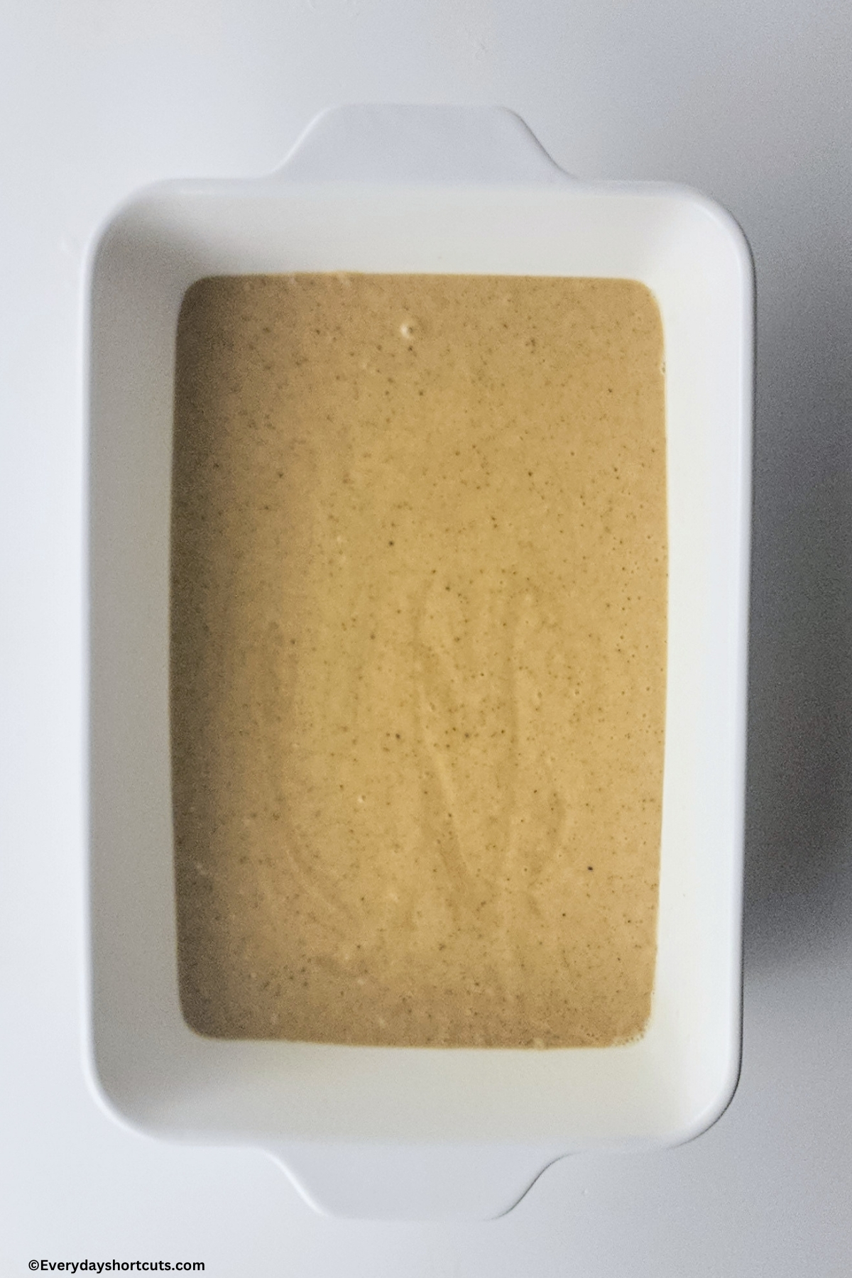 tres leches cake batter in a white baking dish