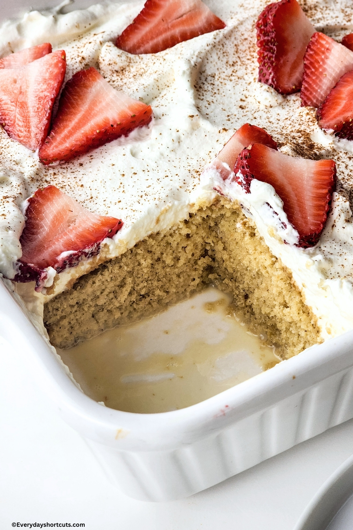 slice taken out of tres leches cake