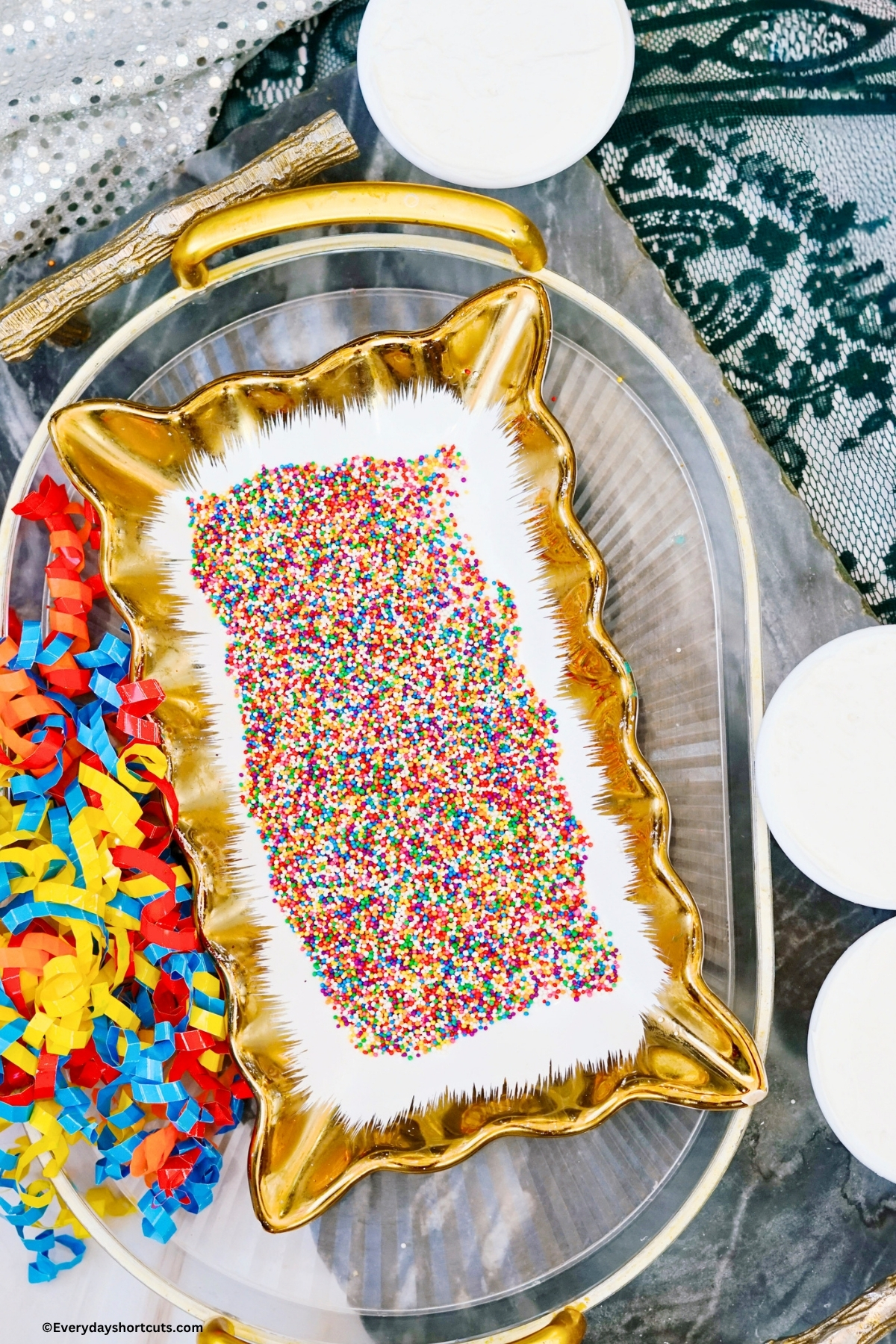 nonpareil sprinkles dumped in a gold and white platter