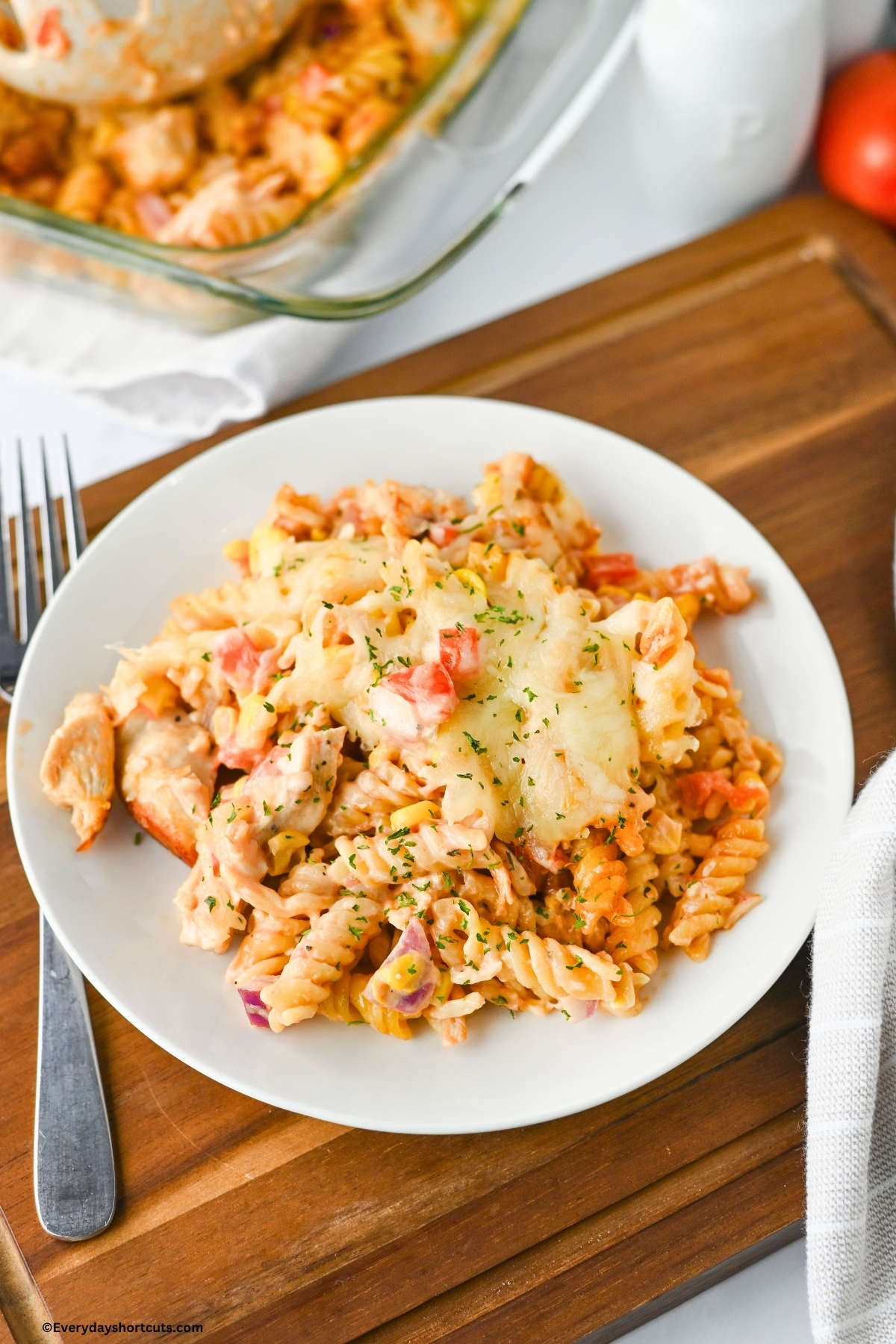 close up of Barbeque Ranch chicken casserole on a white plate next to a fork