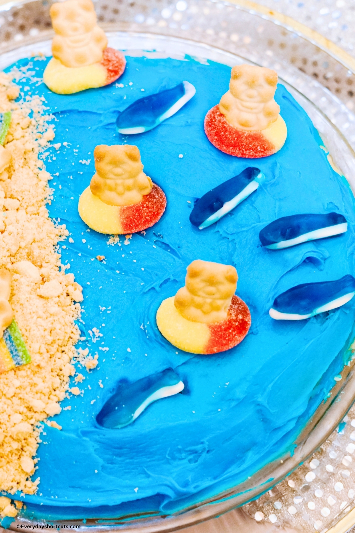 up close of beach cake with gummy sharks