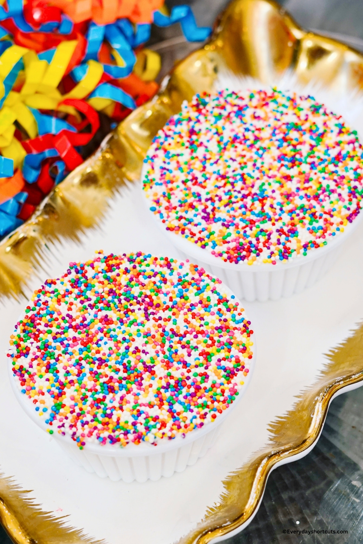 two dot cakes on a gold and white platter