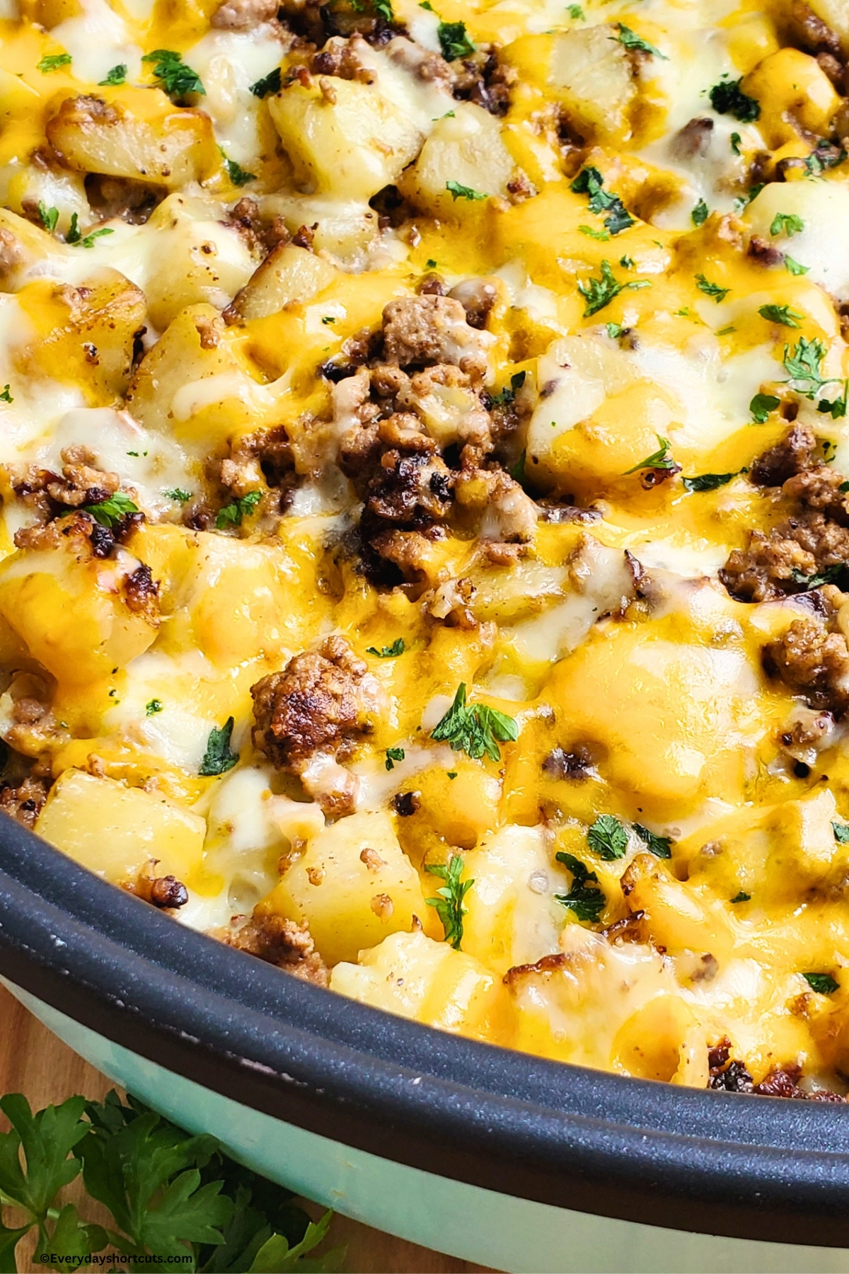 ground beef potatoes and cheese in a pan