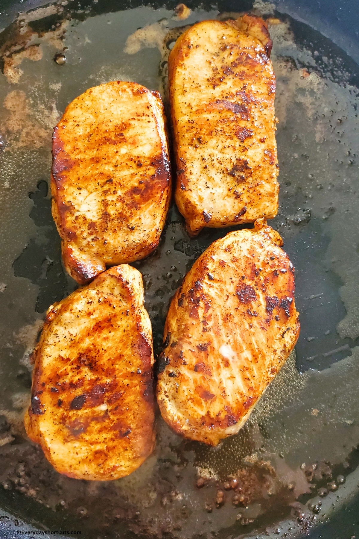cooked boneless pork chops in a pan