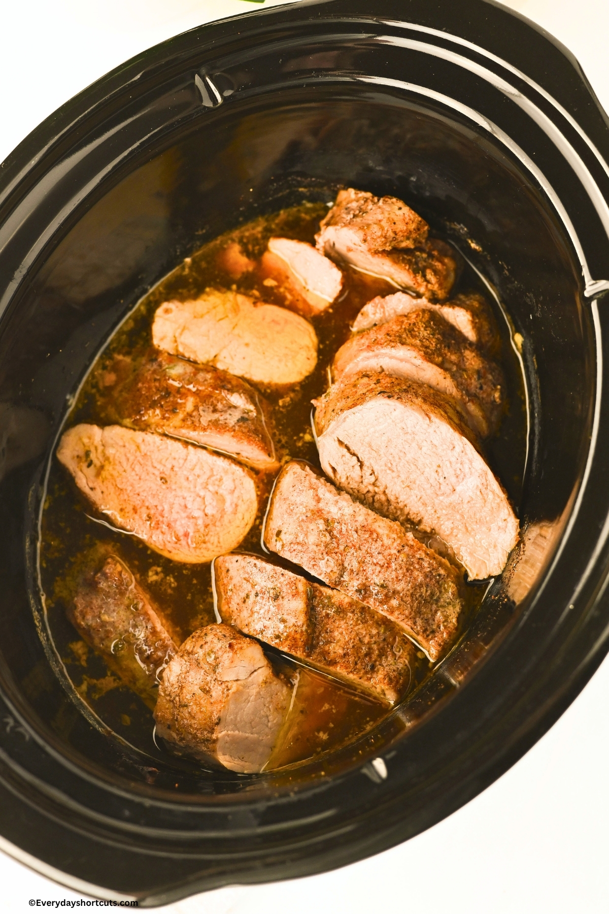 cooked and sliced pork tenderloin in a crockpot