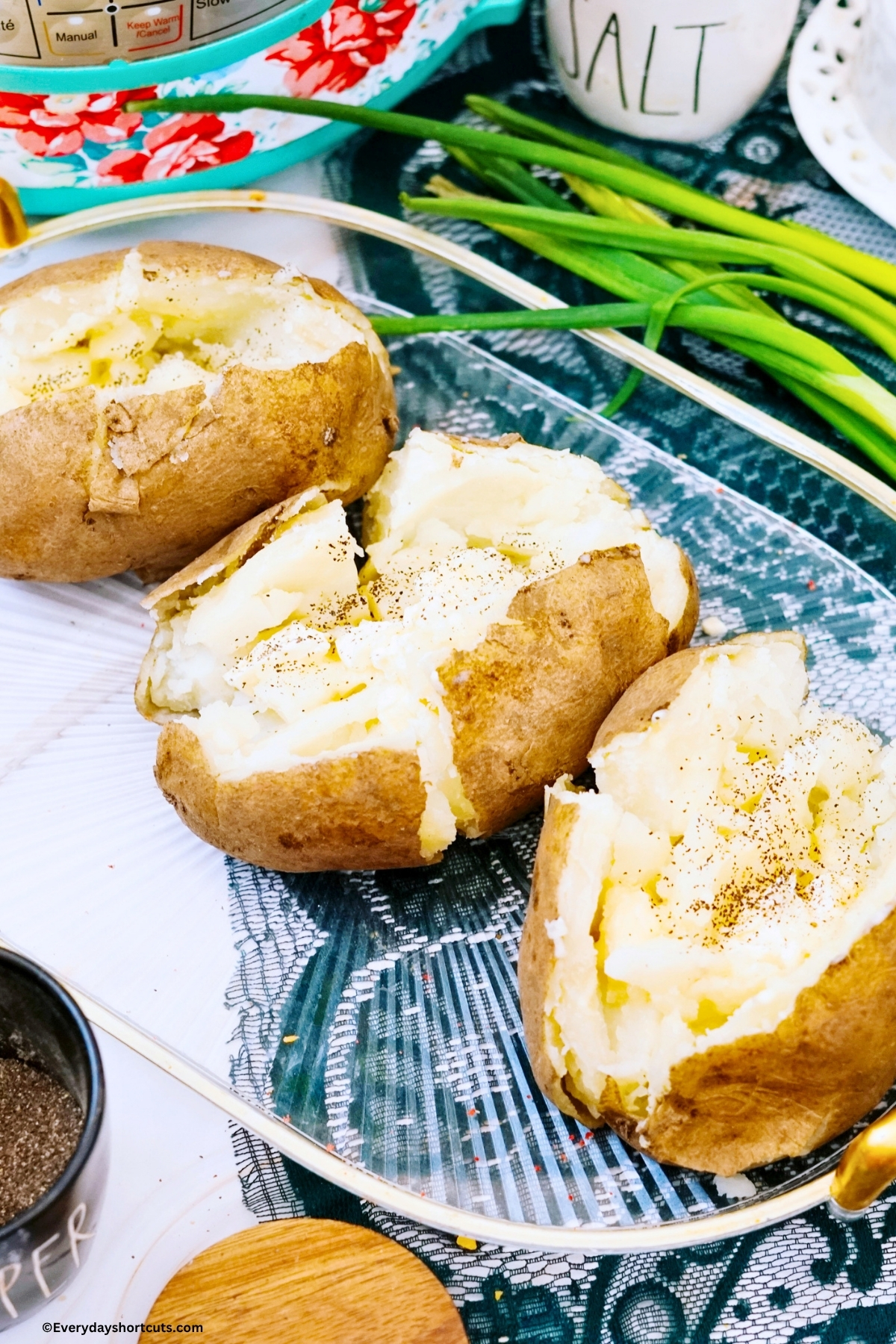 baked potatoes opened and fluff inside on a clear tray