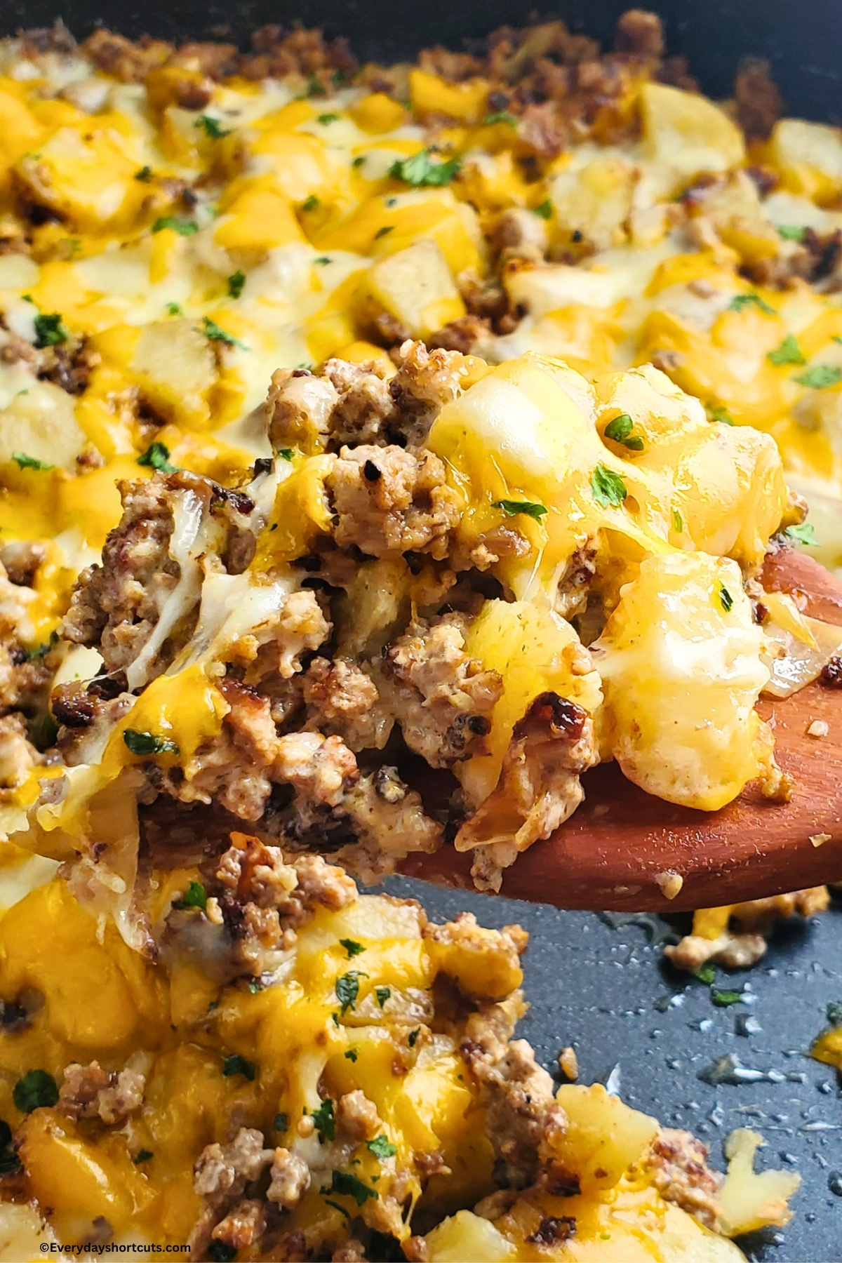 beef and potatoes with cheese on a spatula