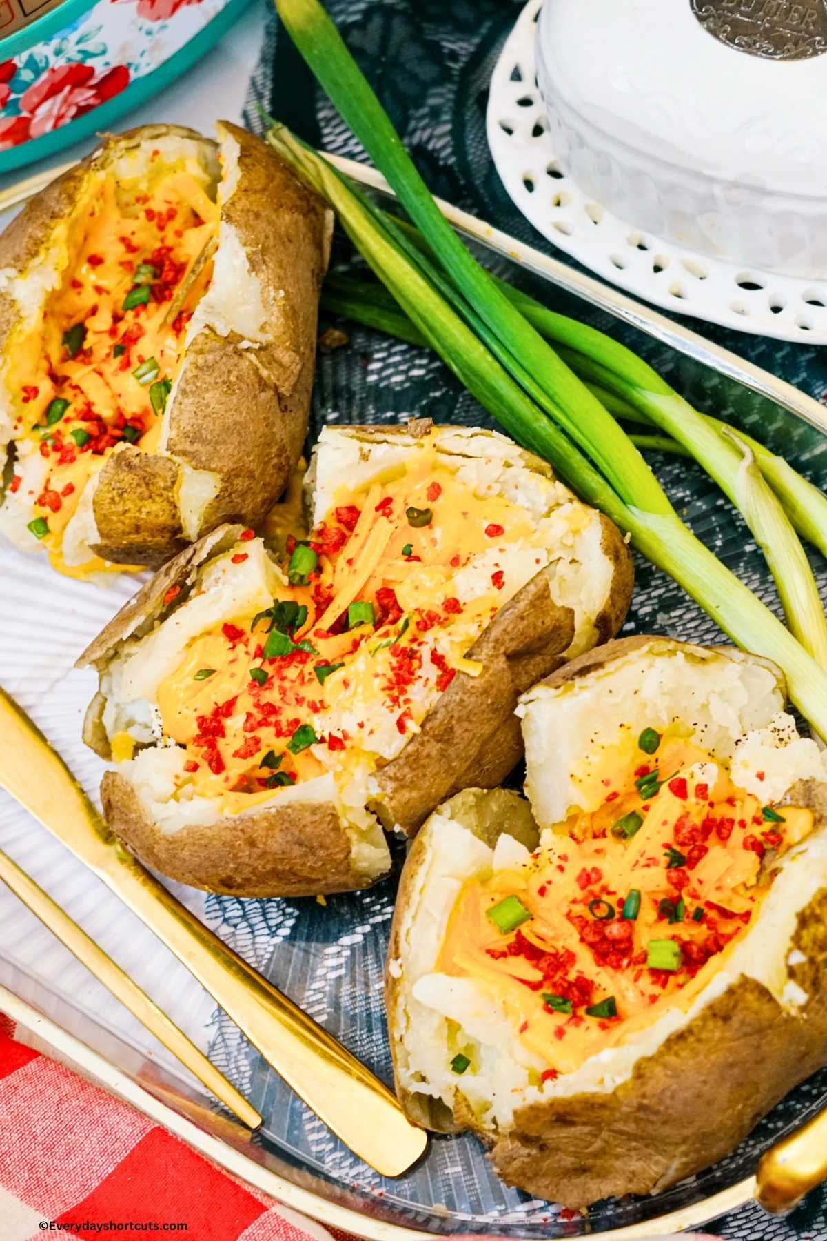 3 loaded baked potatoes on a clear tray