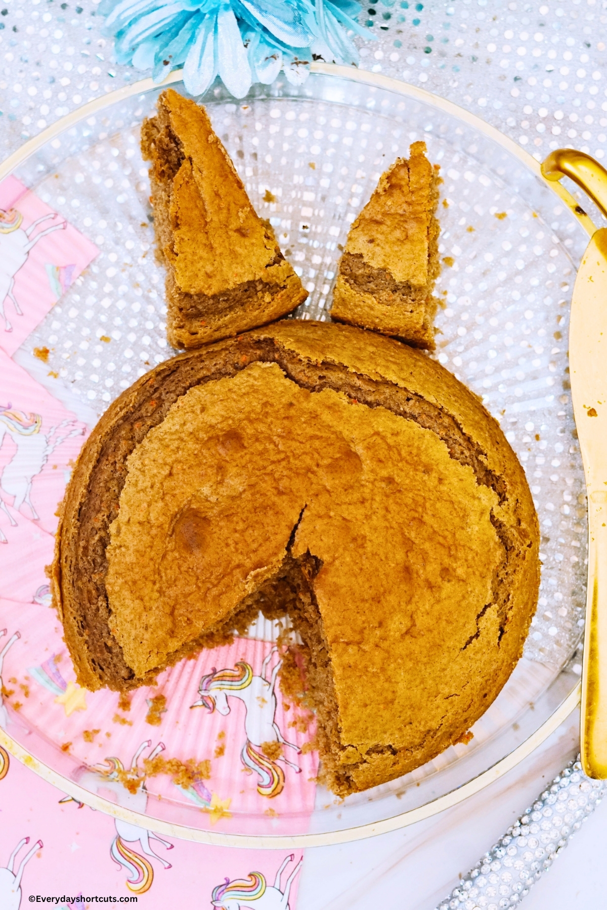 round carrot cake cut to make a unicorn shape