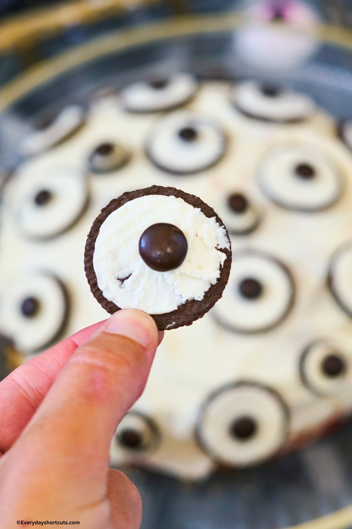twisted off Oreos with white filling shown and a brown M&M on top to look like an eyeball