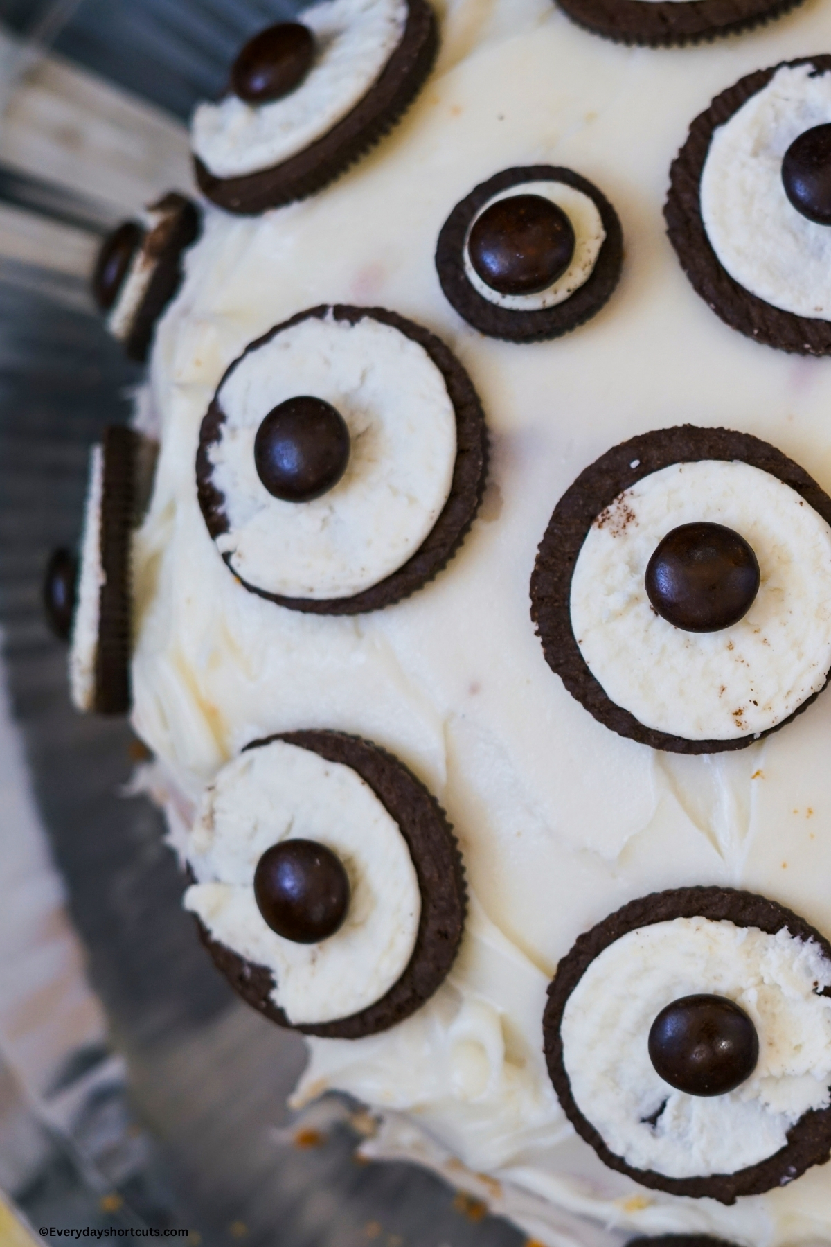 cake frosted white and decorated in Oreos and M&M's to look like eyes