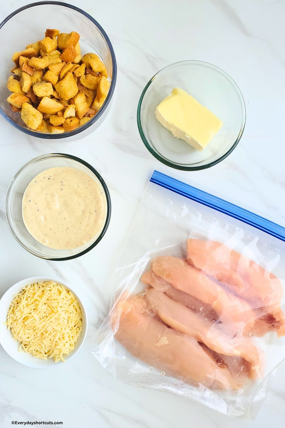 ingredients shown: chicken breasts, Caesar dressing, butter, croutons, shredded Parmesan cheese