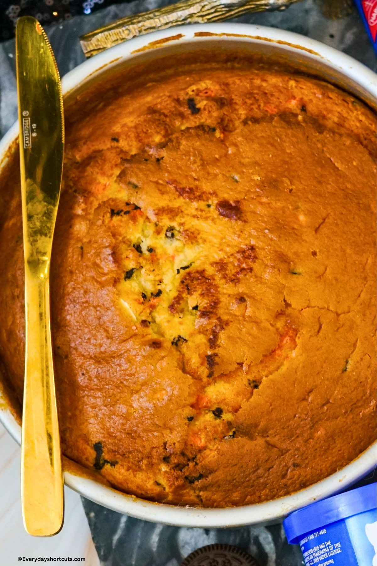 bake funfetti cake in a round pan next to a knife