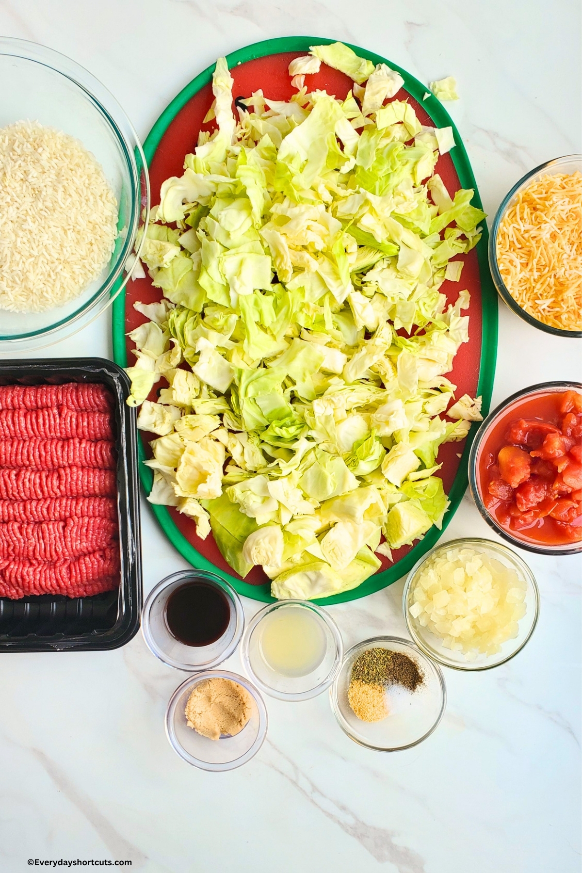 ingredients shown: ground beef, cabbage, diced tomatoes, onions, lemon juice, brown sugar, rice, shredded cheese, worcestershire sauce, garlic powder, Italian seasoning, salt and pepper