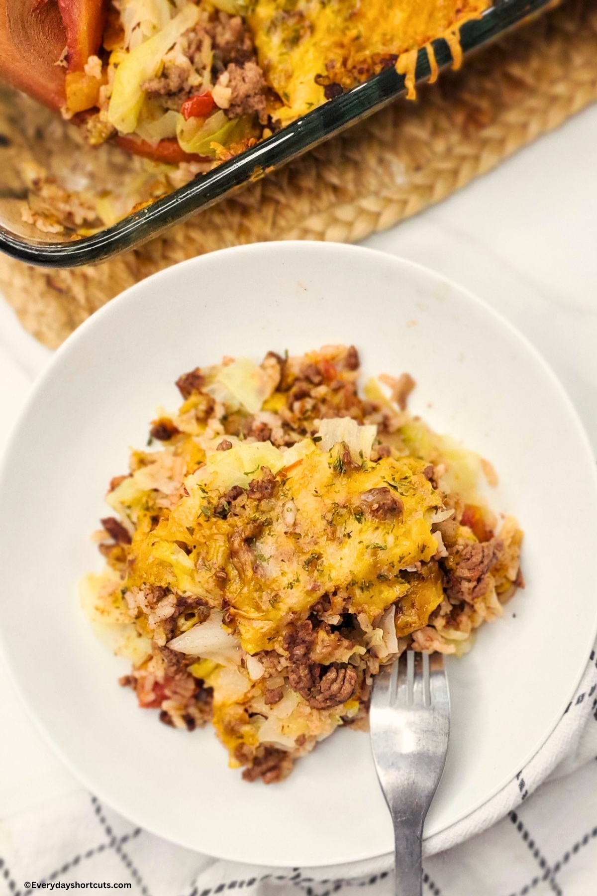 unstuffed cabbage roll on top of a white plate next to a fork