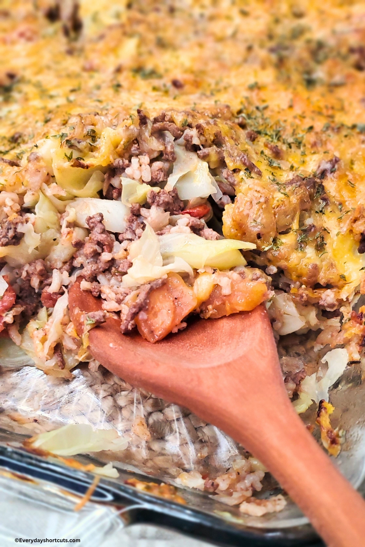 a wooden spoon inside a cabbage roll casserole