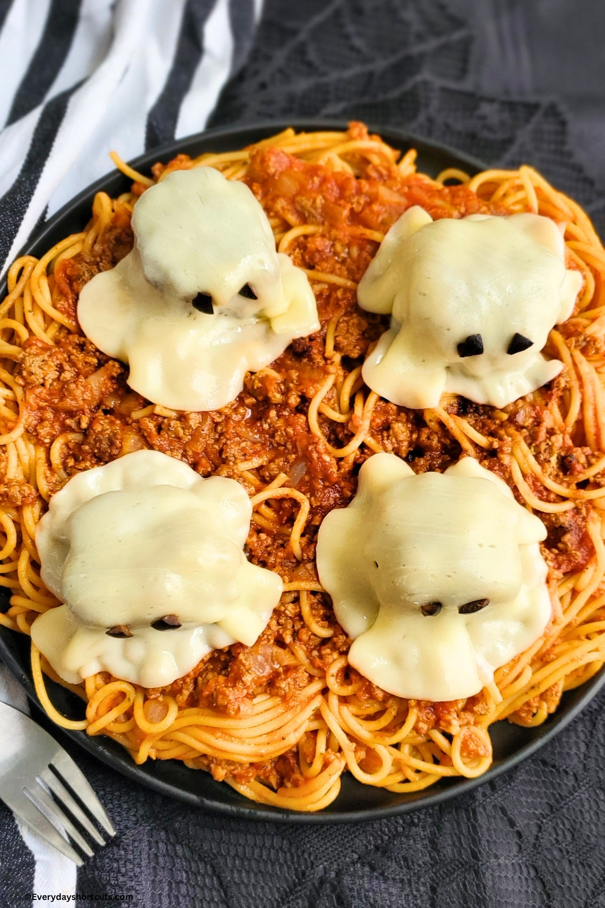 meatball ghosts on top of a plate of spaghetti