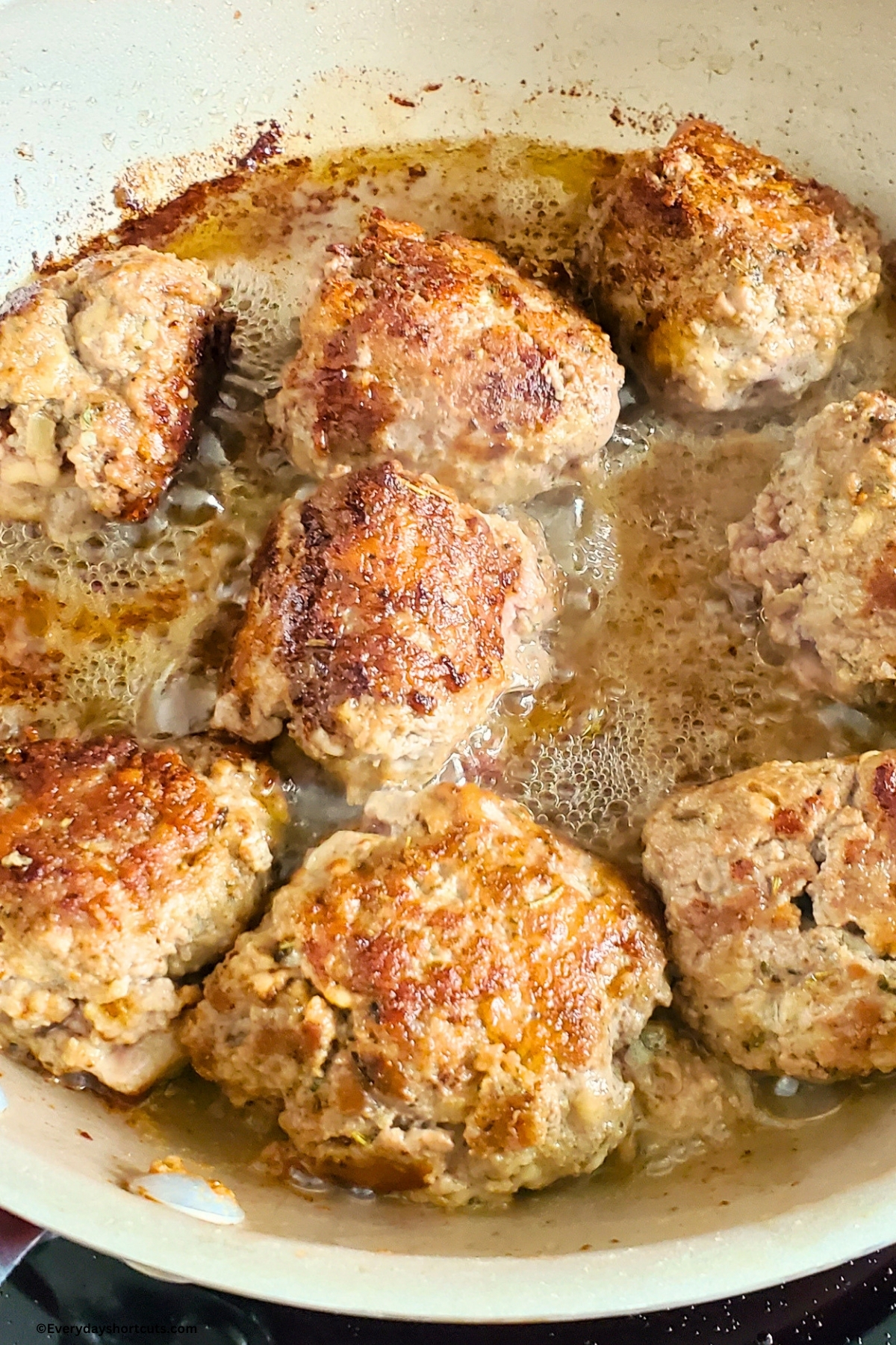 meatballs cooking in a pan