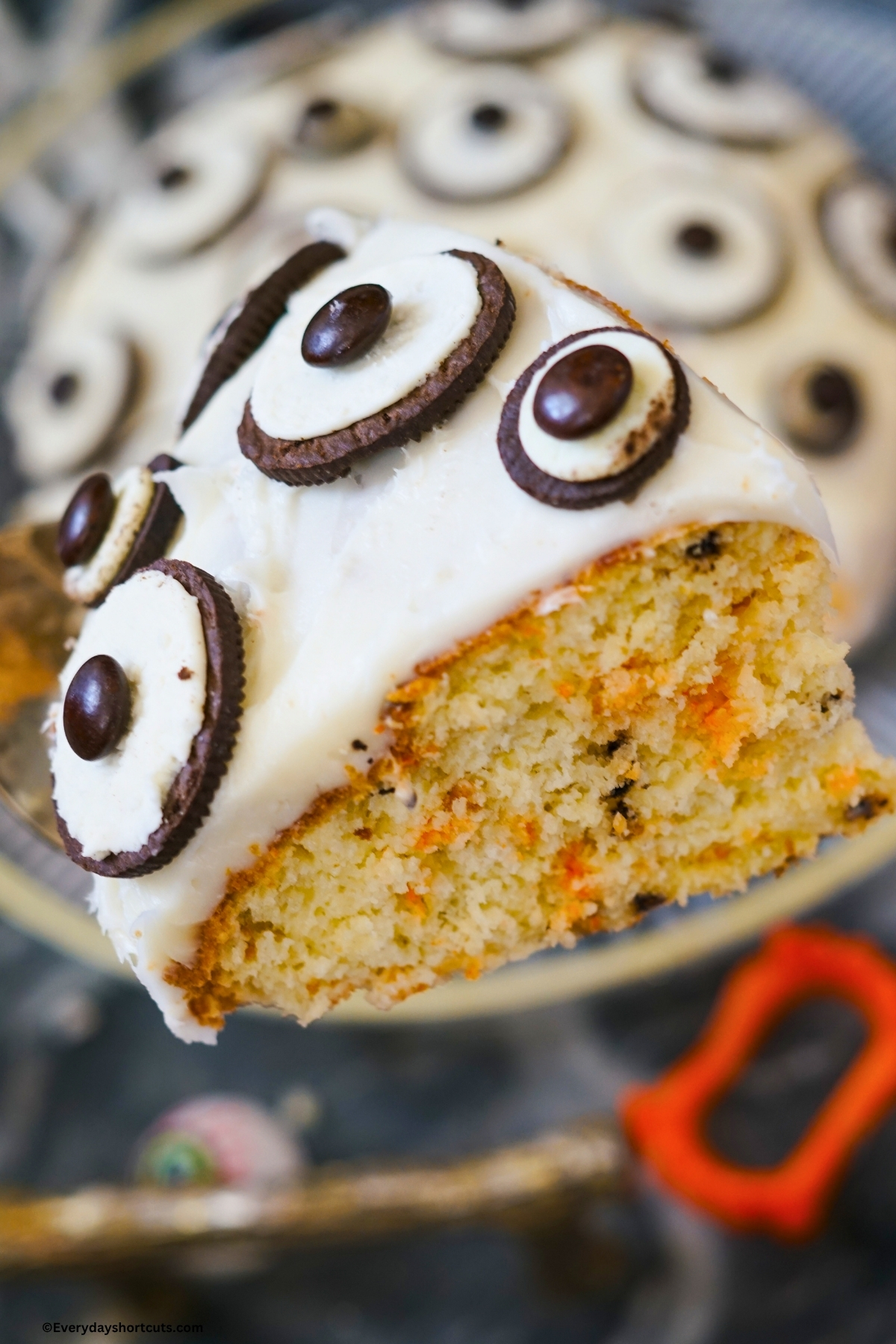 slice of funfetti cake on a spatula with Oreo eyeballs