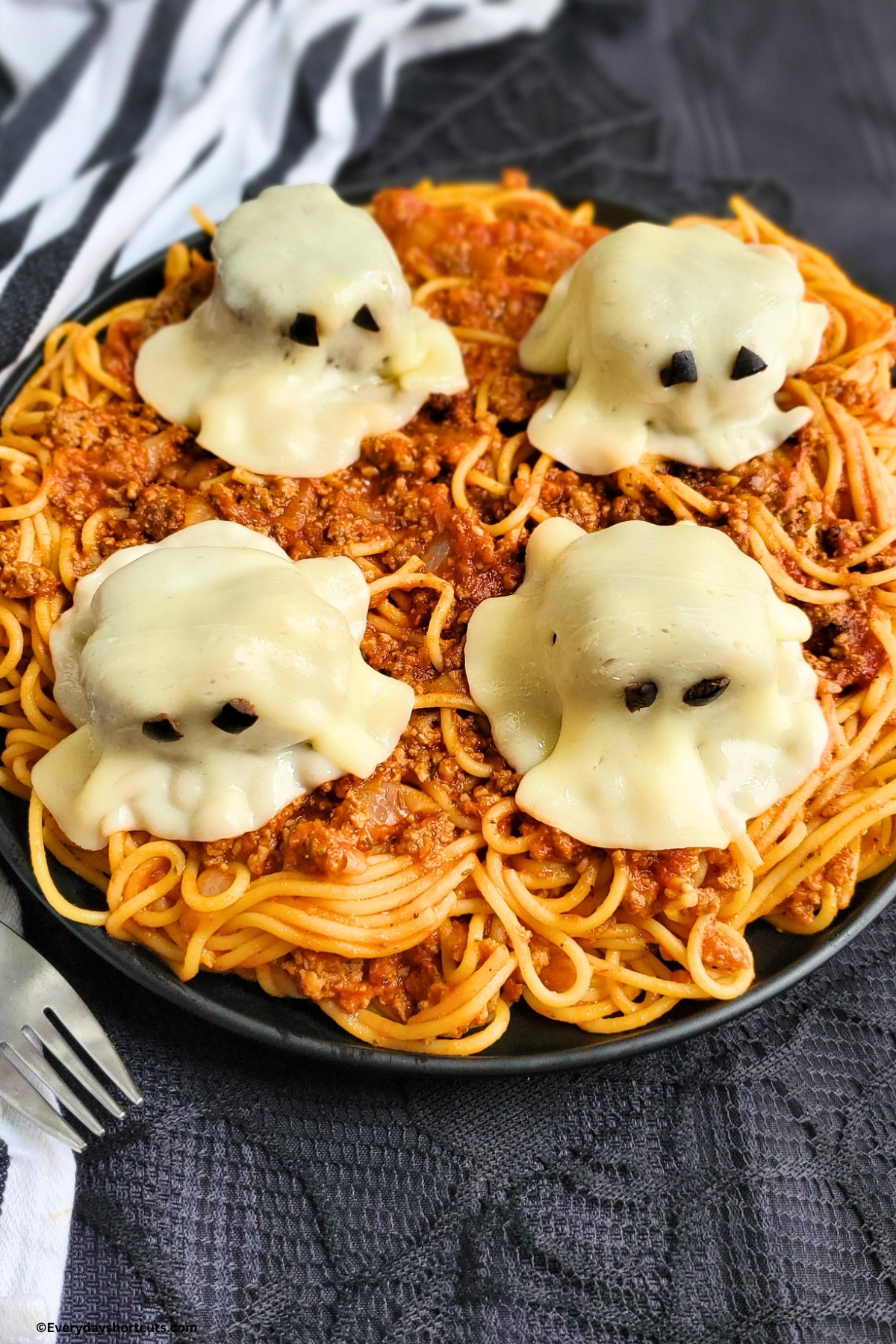 a plate of spaghetti and ghost meatballs